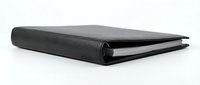 Closed black leather notebook with blank pages isolated on white background, ready for design mockups, branding presentations, and stationery product displays.