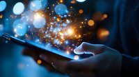 Magical glowing sparkles and bokeh lights emerging from smartphone screen in dark environment, creating ethereal digital transformation effect.