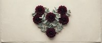 Heart-shaped arrangement of dark burgundy dahlia flowers with eucalyptus leaves on neutral beige background for romantic wedding Valentine's Day decor.
