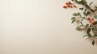 Branch with orange berries and green leaves on beige background, corner composition with copy space for seasonal greeting cards and social media posts.