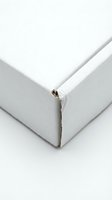 White cardboard box corner detail showing clean edges and professional packaging design for shipping and storage solutions.