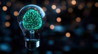 Glowing digital brain inside light bulb on dark background with bokeh lights, representing artificial intelligence, innovation and creative thinking.