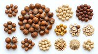 Assorted nuts and legumes isolated on white background, including hazelnuts, macadamia, chickpeas and peanuts for food, nutrition and cooking design projects.