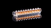 Glass test tube rack with amber liquid samples in laboratory setting, reflecting on black surface. Scientific research and chemical analysis concept.