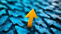 Yellow upward arrow rising above blue textured arrows background, symbolizing success, leadership and standing out from competition. Business concept for growth.