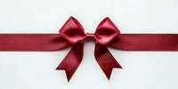 Red satin ribbon bow on white background for gift wrapping, holiday decoration and festive celebration design projects.
