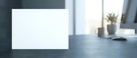 Blank white paper card mockup on modern office desk with blurred background for branding and design presentations.
