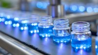 Glass jars with bright blue glowing liquid in scientific laboratory setting, illuminated research samples on dark surface with bokeh background effect.