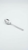 Stainless steel tablespoon isolated on white background for kitchen and dining design projects.