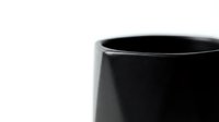 Black ceramic mug close-up on white background, minimalist kitchen tableware for coffee tea drinking, modern home decor and beverage presentation.