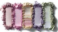 Crushed makeup eyeshadow powder swatches in pastel pink, beige, purple and mint green shades on white background, cosmetic texture closeup macro photography.