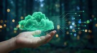 Hand holding glowing green cloud with digital circuit connections representing cloud computing technology and data storage solutions for business.