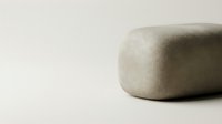 Minimalist beige stone or ceramic object with smooth rounded edges on neutral background for modern interior design and spa wellness concepts.
