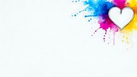 White heart shape with vibrant colorful paint splashes in blue, pink and yellow on clean background for romantic design projects.