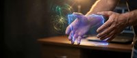 Hands holding glowing holographic cube with digital data visualization and light effects, representing technology, innovation, and future computing solutions.