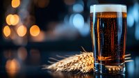 Glass of dark craft beer with wheat ears on dark background with bokeh lights, fresh foam and bubbles for restaurant menu and advertising.