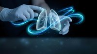 Medical professional examining holographic lung anatomy with glowing blue digital effects for healthcare technology and respiratory system analysis.