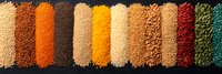 Colorful assortment of various legumes, grains and seeds arranged in neat rows on dark surface. Perfect for healthy cooking, nutrition and organic food concepts.
