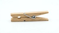 Wooden clothespin with metal spring mechanism isolated on white background, ready for laundry, household cleaning, and craft design projects.