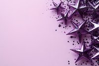 Purple glittering stars and sparkles scattered on pastel pink background creating festive border composition with copy space for holiday designs.