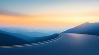 Curving mountain road at sunset with layered mountain silhouettes and orange sky creating dramatic perspective. Minimalist landscape for travel concepts.