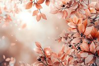 Dreamy coral-colored leaves and branches create soft natural composition with bokeh light effects against blurred background. Romantic floral art design.