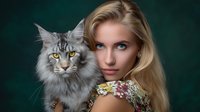 Young blonde woman with blue eyes posing with majestic Maine Coon cat against dark green background. Elegant portrait showcasing special bond between pet owner and feline companion.