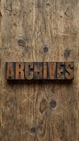Vintage wooden letterpress blocks spelling ARCHIVES on weathered rustic wood background for historical documentation and storage concepts.