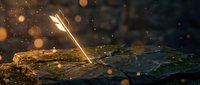 Golden feather resting on moss-covered rock with magical bokeh lights and sparkling particles creating enchanting forest atmosphere for fantasy designs.