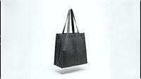Black reusable shopping bag with handles isolated on white background for eco-friendly retail and sustainable lifestyle concepts.