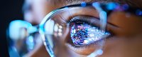 Close up view of eye wearing glasses reflecting digital data visualization and technology interface in blue neon colors, showing modern tech concept and digital transformation.