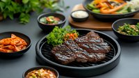 Grilled beef steak on hot plate served with kimchi and traditional Korean side dishes on dark background, gourmet Asian cuisine.