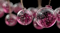 Pink glass Christmas ornaments filled with sparkling beads hanging against dark background for holiday decorating and festive seasonal celebrations.