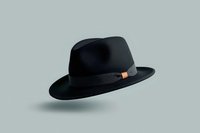 Classic black fedora hat with orange band detail floating on gray background, isolated object for fashion and accessory design projects.