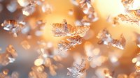 Delicate ice crystals with intricate patterns floating in warm golden light creating magical winter atmosphere. Natural macro photography shows frozen water formations.
