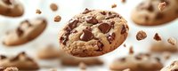 Chocolate chip cookie with chunks and crumbs floating in mid-air against white background, perfect for bakery advertising and food design projects.