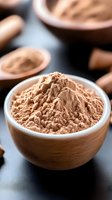 Fresh cocoa powder in wooden bowl on dark background, close up view with selective focus. Natural baking ingredient for chocolate desserts.