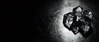 Polyhedral dice cluster illuminated on textured dark surface, suitable for tabletop gaming, fantasy content, and role-playing game marketing materials.
