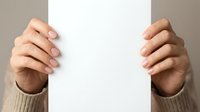 Hands holding blank white paper card against neutral background, suitable for mockup, advertising, and promotional designs.