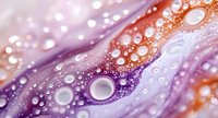 Abstract fluid art with colorful paint drops and bubbles in purple, pink and orange gradient creating dynamic liquid texture for modern design backgrounds.
