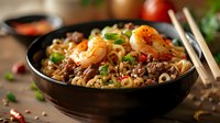 Asian noodles with shrimp and minced meat in black bowl, garnished with green onions. Selective focus on spicy stir-fried seafood dish with rich sauce.