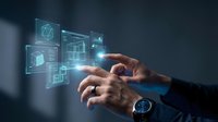 Businessman hands interacting with futuristic holographic interface displaying digital icons and data visualization elements in modern technology concept.