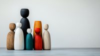 Minimalist wooden figures in different colors standing together on gray background, representing diversity, unity and teamwork in business or community.