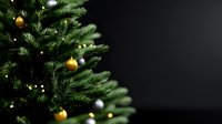 Decorated Christmas tree with gold and silver ornaments against dark background, creating elegant holiday atmosphere with copy space for seasonal designs.