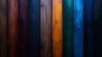 Colorful wooden planks background with rich stained textures in brown, purple, navy, orange, teal and blue. Natural wood grain pattern creates dramatic vertical stripes.