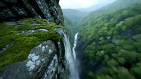 Dramatic aerial view of mountain waterfall cascading over moss-covered cliff edge into deep green valley, creating powerful nature landscape with misty atmosphere.