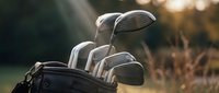 Golf clubs in bag at sunset on course with warm golden light creating peaceful sporting atmosphere for recreation and leisure activities.