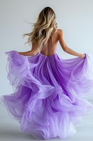 Young woman with blonde hair in flowing purple tulle gown dancing gracefully, back view against light background, hair in motion, dress billowing dramatically.