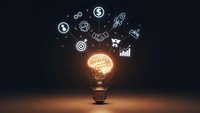 Glowing lightbulb with brain inside surrounded by business icons on dark background representing innovation, creativity and entrepreneurial thinking.