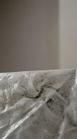 Abstract concrete texture with flowing organic patterns and neutral gray tones for modern interior design and architectural backgrounds.